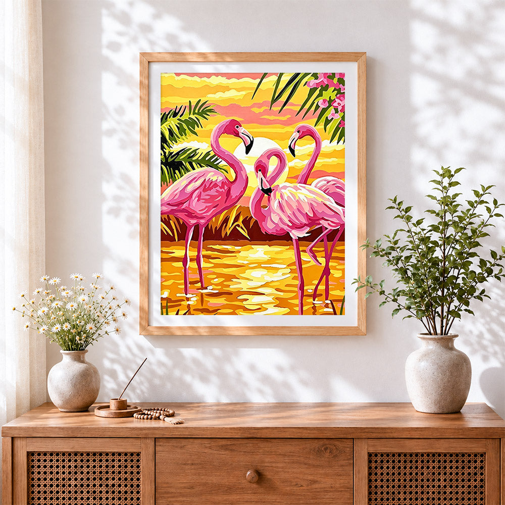 Finished tropical pink flamingos at sunset cross stitch artwork displayed