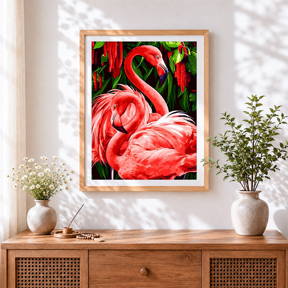 Finished tropical pink flamingos cross stitch artwork displayed