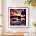 Finished tropical sunset in wine glass cross stitch artwork displayed
