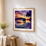 Tropical sunset in wine glass cross stitch artwork displayed on wall as home decor