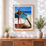 Finished turquoise boat on beach cross stitch artwork displayed
