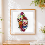 Finished twin sugar skulls cross stitch artwork displayed