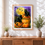 Finished two black cats on pumpkins under a full moon cross stitch artwork displayed