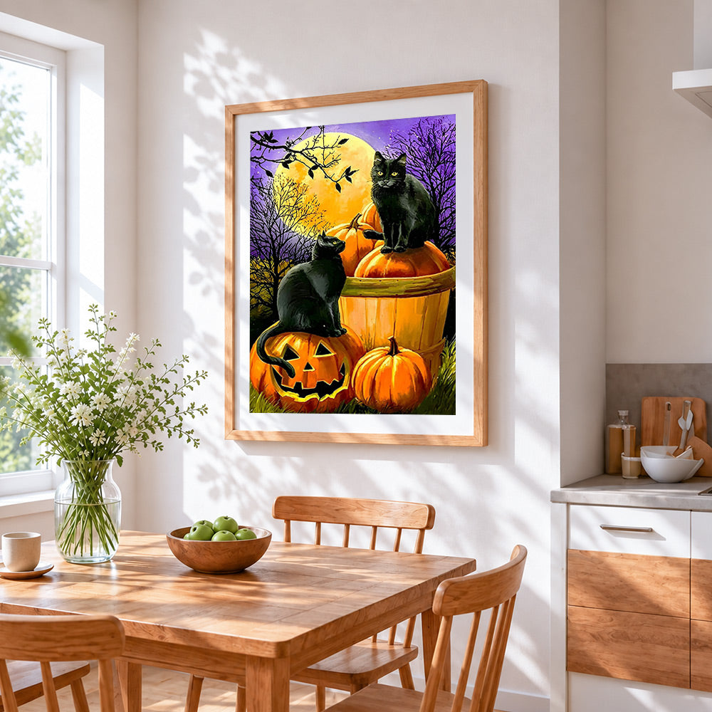 Two black cats on pumpkins under a full moon cross stitch artwork displayed on wall as home decor