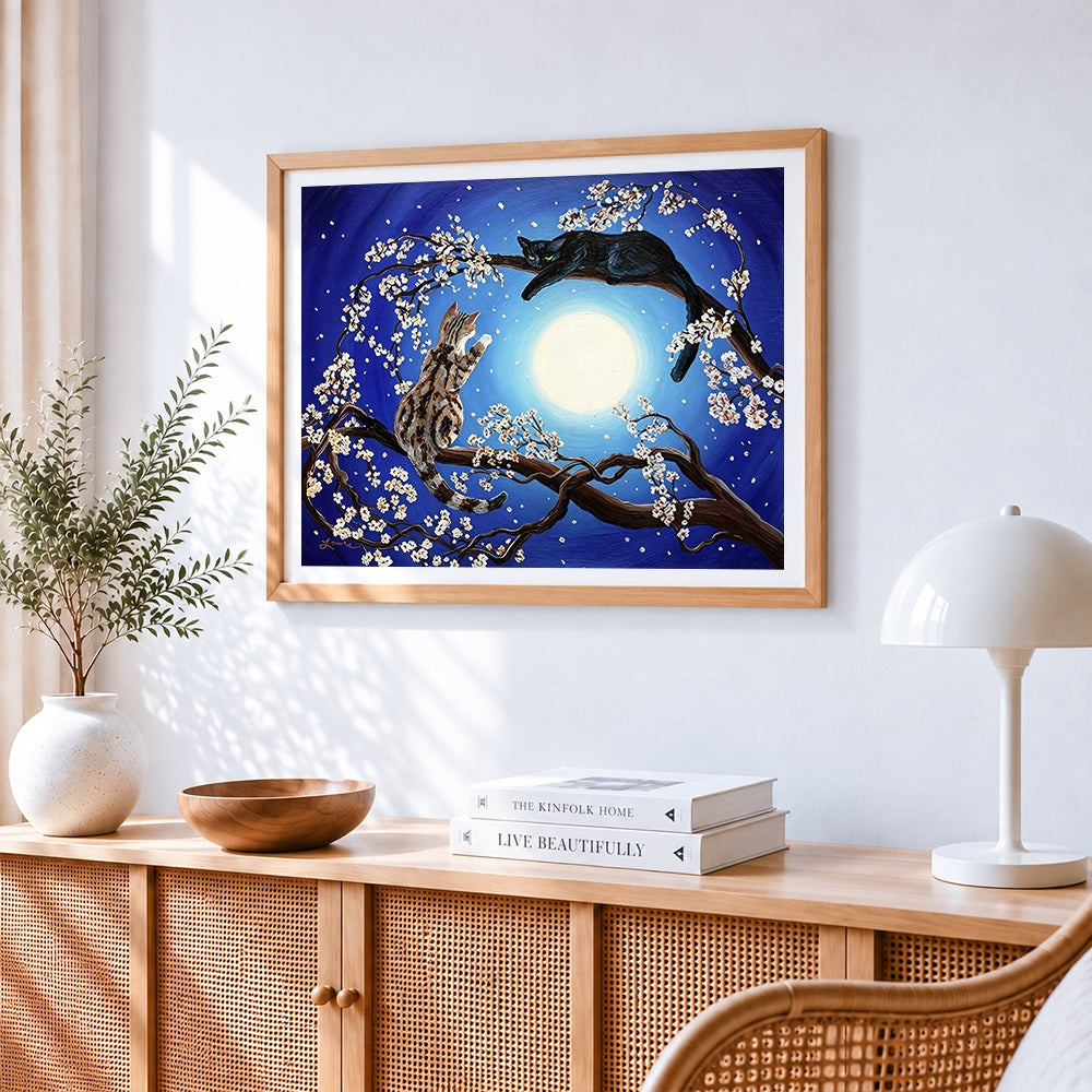 Two cats in a blossom tree cross stitch artwork displayed on wall as home decor