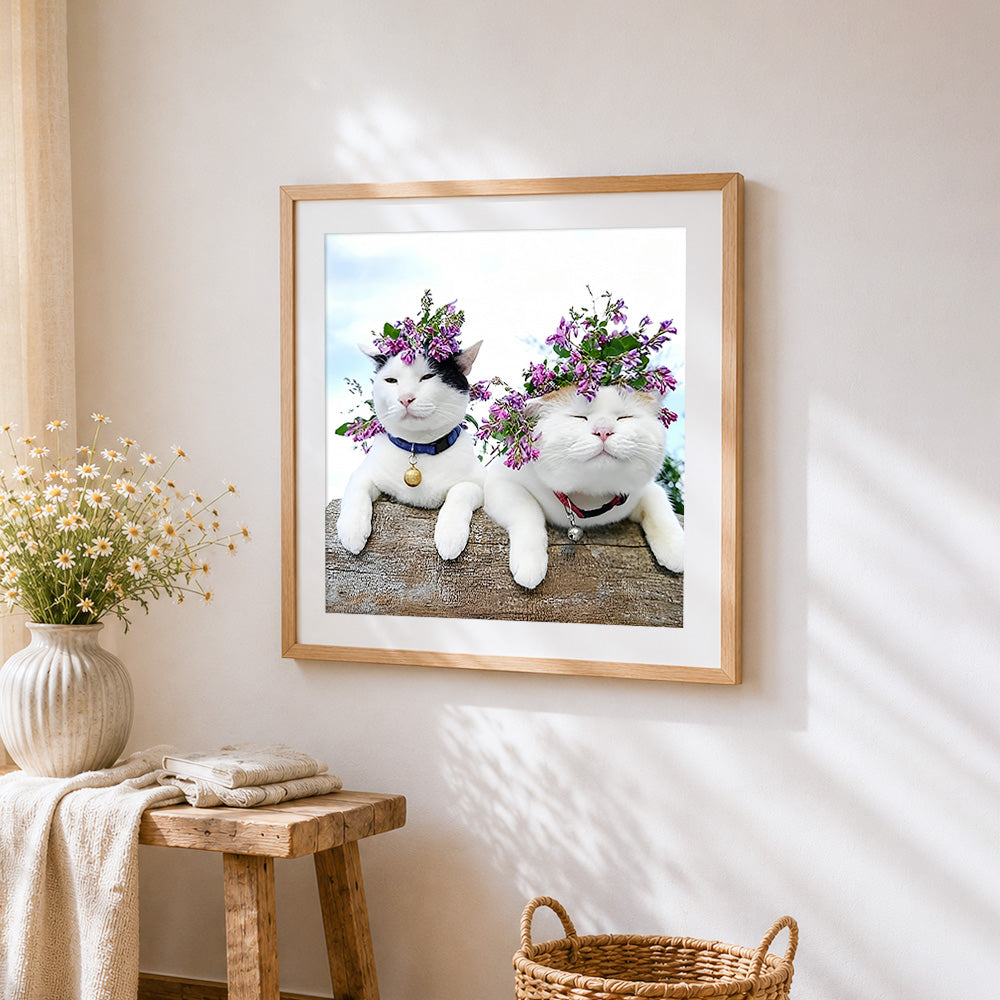 Two cats with flower crowns cross stitch artwork displayed on wall as home decor