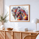 Two colourful abstract horses cross stitch artwork displayed on wall as home decor