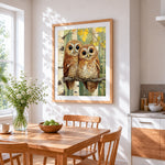 Two cute owls on birch branch cross stitch artwork displayed on wall as home decor