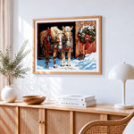 Two horses in the snow with christmas wreath cross stitch artwork displayed on wall as home decor