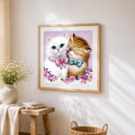 Two kittens kissing cross stitch artwork displayed on wall as home decor