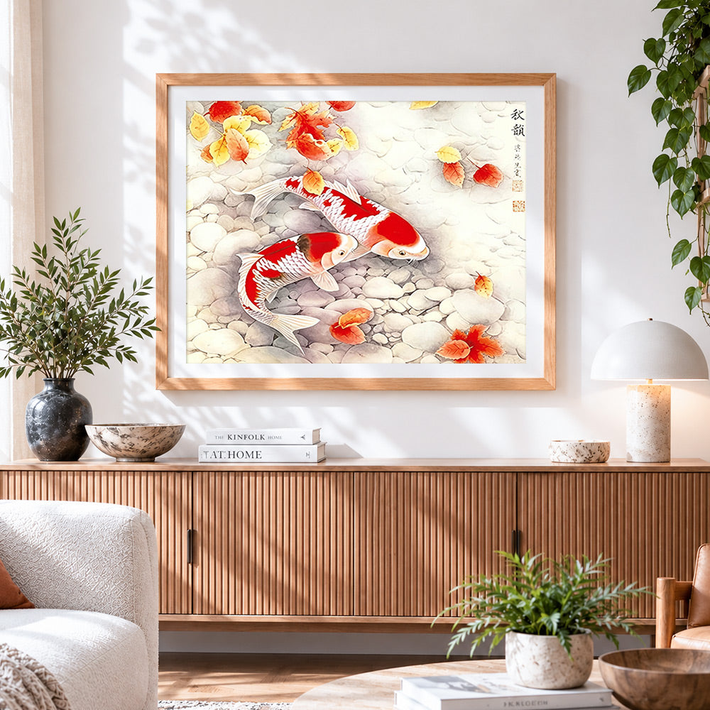 Finished two koi swimming among pebbles and autumn leaves cross stitch artwork displayed