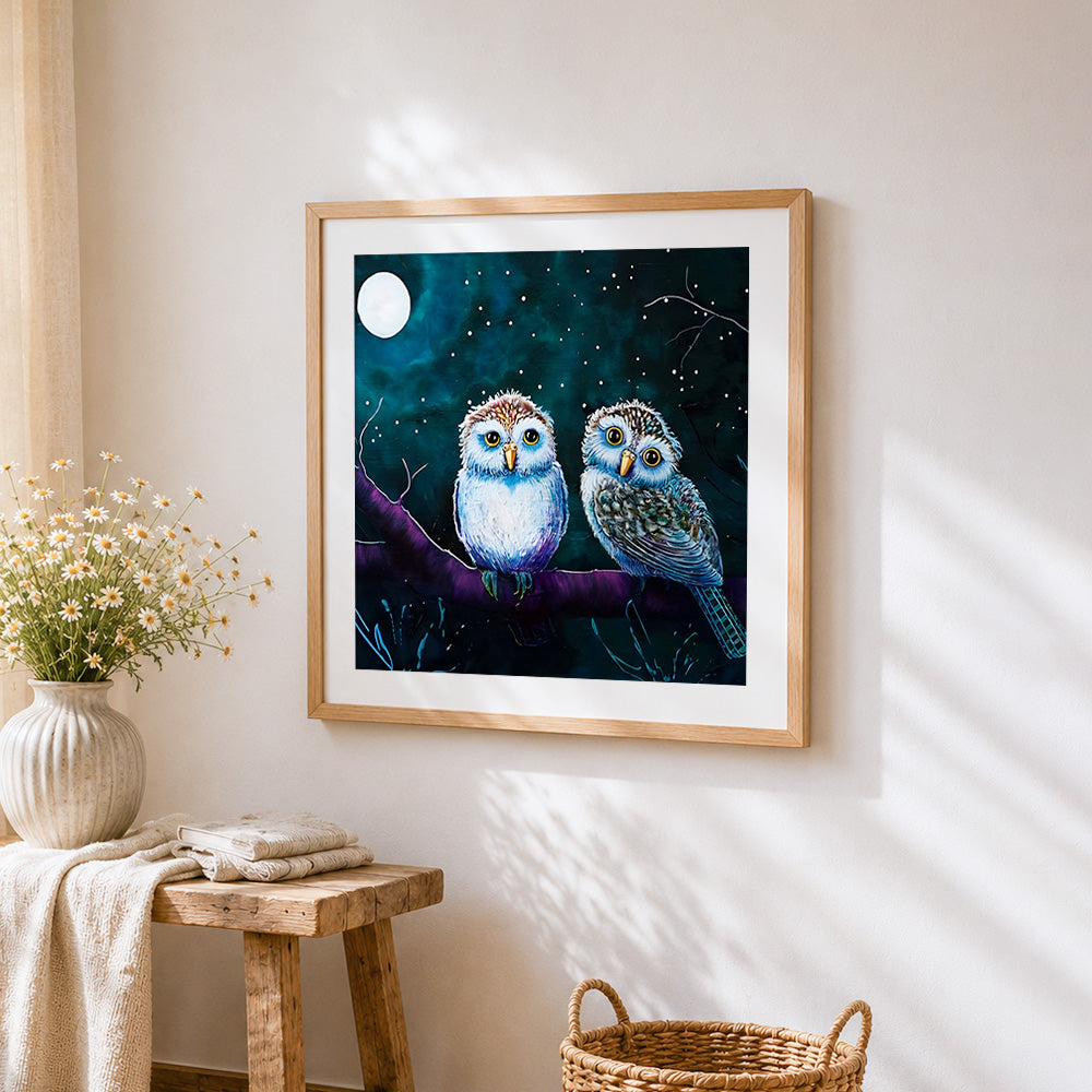 Two owls under the moon cross stitch artwork displayed on wall as home decor
