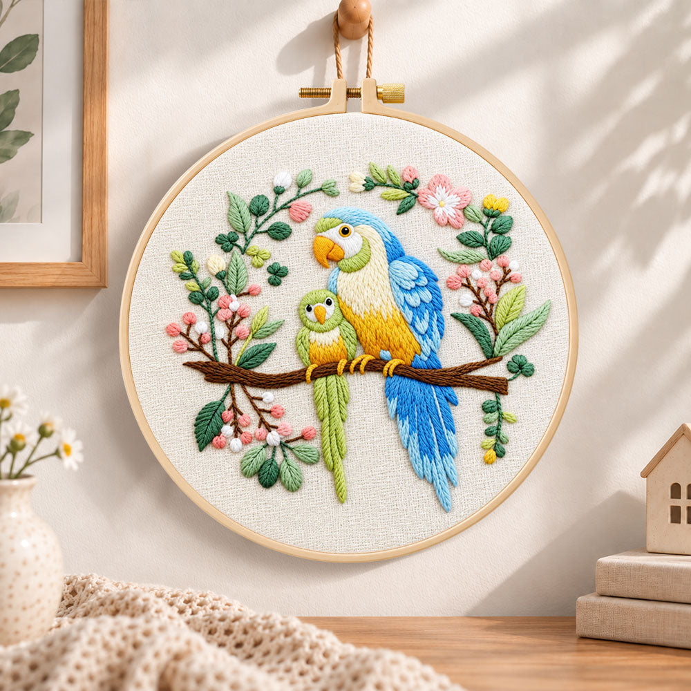 Two parrots on blossom branch embroidery hoop wall art displayed as warm and cosy handmade home decor