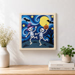 Finished two skeletons dancing at night artwork displayed on a wall