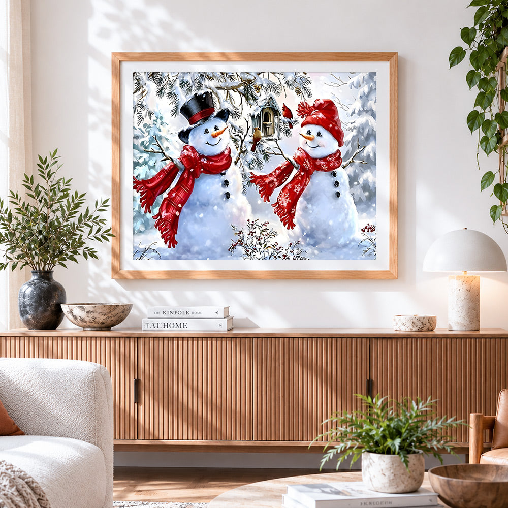 Finished two snowmen with birdhouse cross stitch artwork displayed