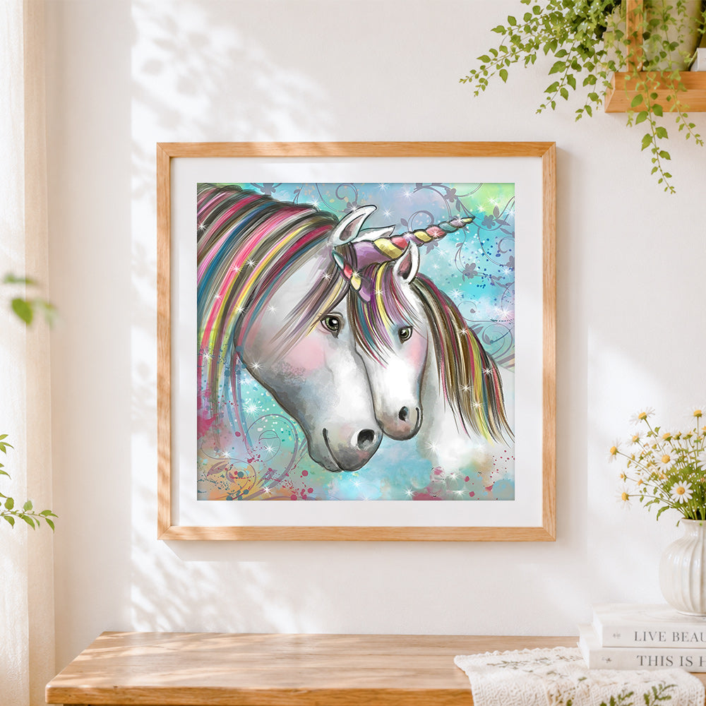 Finished two unicorns with rainbow manes cross stitch artwork displayed