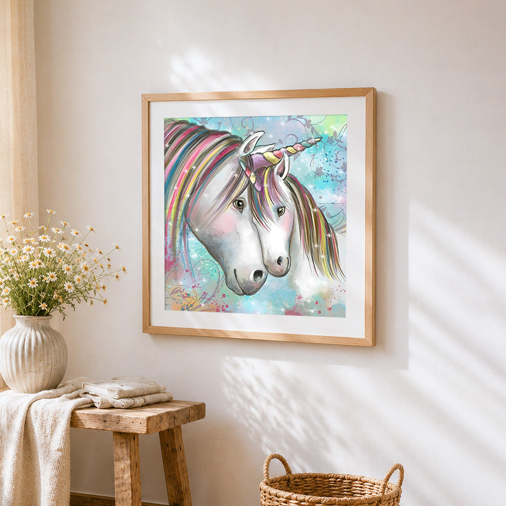 Two unicorns with rainbow manes cross stitch artwork displayed on wall as home decor