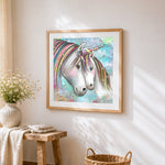 Two unicorns with rainbow manes cross stitch artwork displayed on wall as home decor