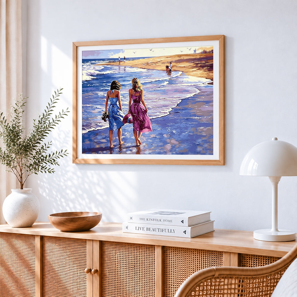 Two women walking on the beach cross stitch artwork displayed on wall as home decor