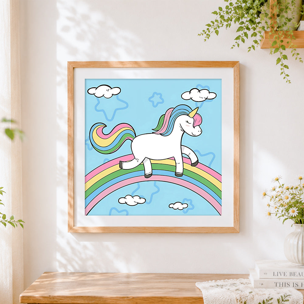Finished unicorn walking on a rainbow cross stitch artwork displayed