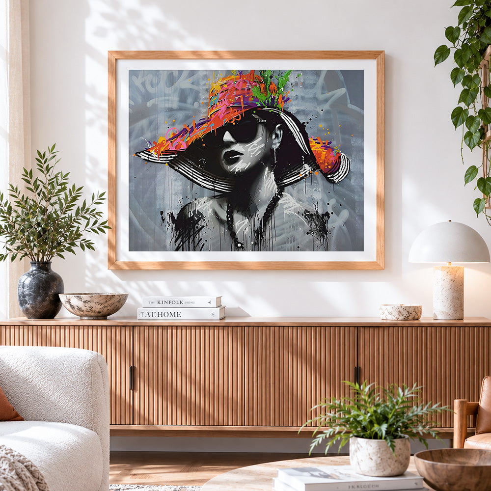 Finished urban graffiti portrait with colourful hat cross stitch artwork displayed