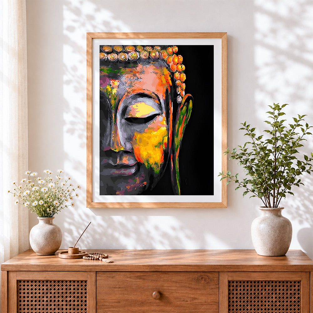 Finished vibrant abstract buddha face cross stitch artwork displayed