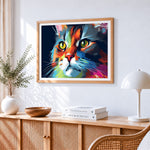 Vibrant abstract cat portrait cross stitch artwork displayed on wall as home decor