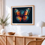 Vibrant butterfly on dark background cross stitch artwork displayed on wall as home decor