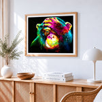 Vibrant chimpanzee splatter cross stitch artwork displayed on wall as home decor
