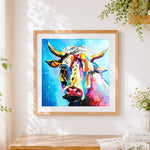 Finished vibrant colourful cow portrait cross stitch artwork displayed