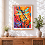 Finished vibrant dragonflies in abstract sunset cross stitch artwork displayed