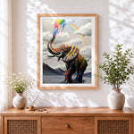 Finished vibrant elephant with rainbow cross stitch artwork displayed