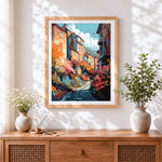 Finished vibrant european town cross stitch artwork displayed