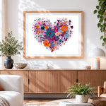 Finished vibrant floral heart cross stitch artwork displayed