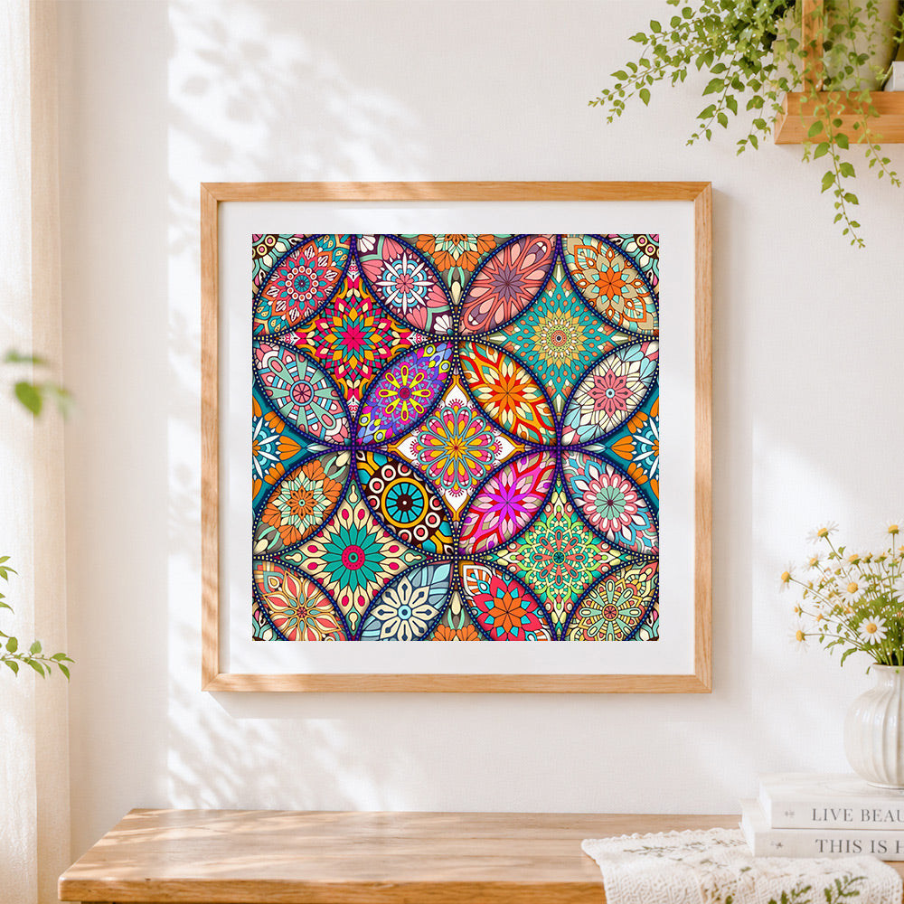 Finished vibrant floral mandala collage cross stitch artwork displayed