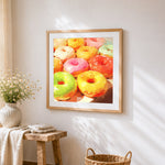 Vibrant glazed donuts cross stitch artwork displayed on wall as home decor