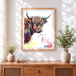 Finished vibrant ink and watercolour highland cow cross stitch artwork displayed