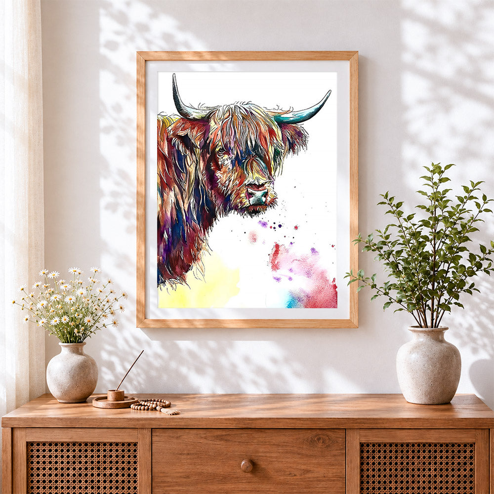 Finished vibrant ink and watercolour highland cow cross stitch artwork displayed