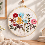 Vibrant mixed blooms embroidery hoop wall art displayed as warm and cozy handmade home decor