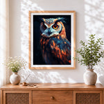 Finished vibrant owl portrait cross stitch artwork displayed