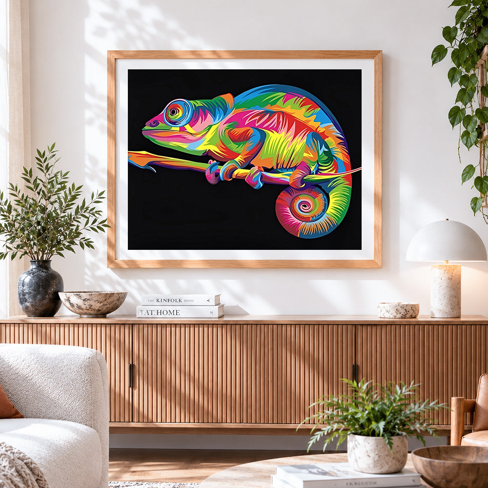 Finished vibrant pop art chameleon cross stitch artwork displayed