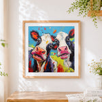 Finished vibrant pop art cows cross stitch artwork displayed