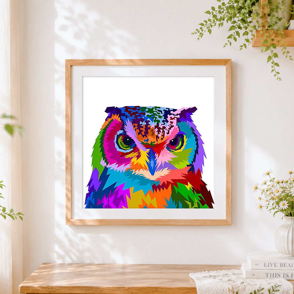Finished vibrant pop art owl portrait cross stitch artwork displayed