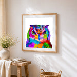 Vibrant pop art owl portrait cross stitch artwork displayed on wall as home decor