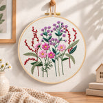 Vibrant purple floral embroidery hoop wall art displayed as warm and cozy handmade home decor