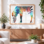 Finished vibrant rainbow watercolour zebra cross stitch artwork displayed
