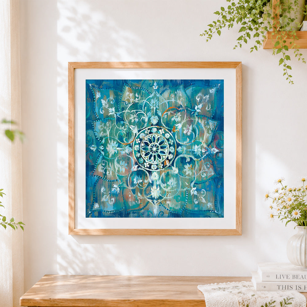 Finished vibrant turquoise mandala cross stitch artwork displayed
