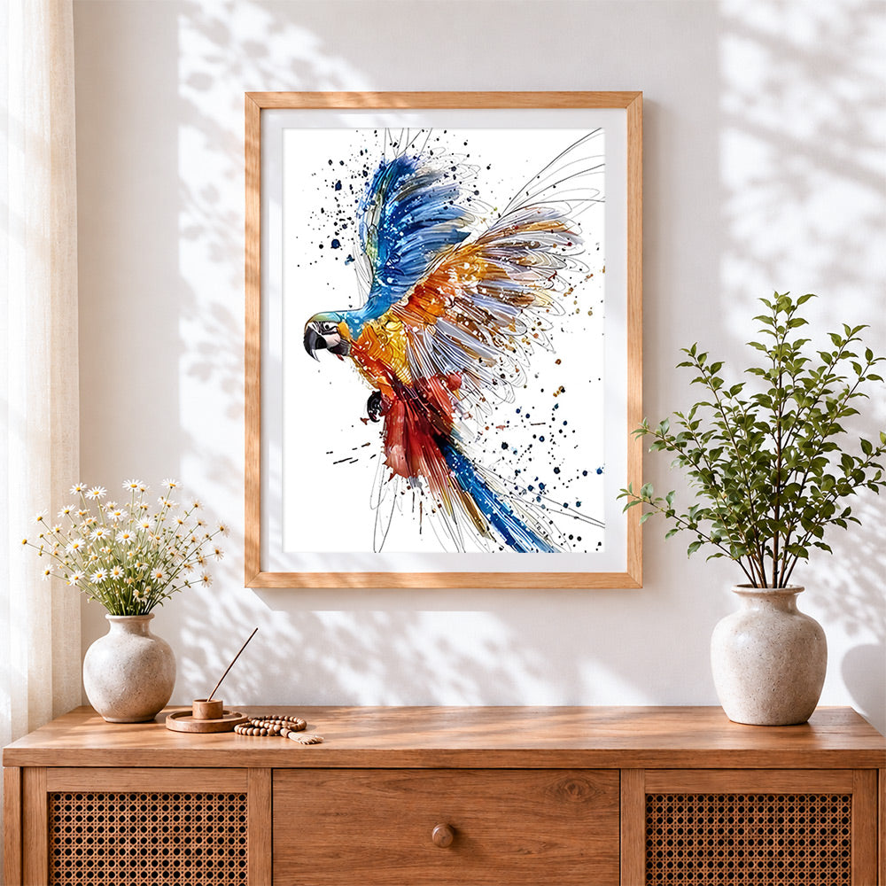 Finished vibrant watercolour macaw flying cross stitch artwork displayed