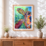 Finished vibrant watercolour sea turtle close up cross stitch artwork displayed