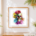 Finished vibrant watercolour skull and roses cross stitch artwork displayed